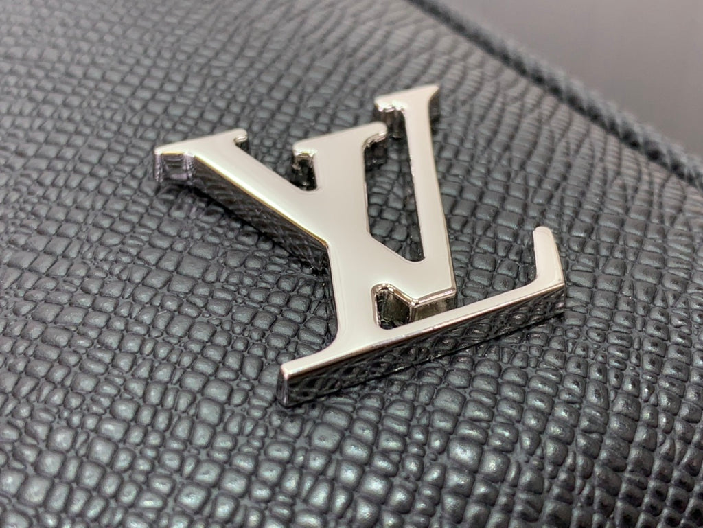 Louis Vuitton LV emblem on black textured leather inlay, gold-tone metal logo