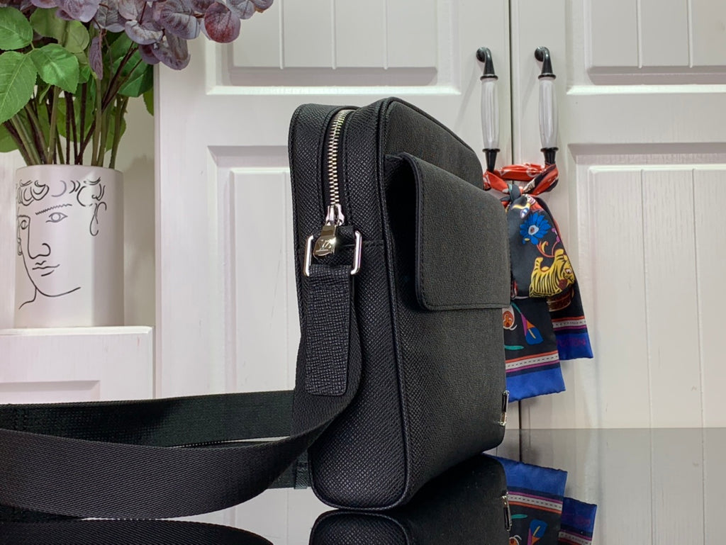 Louis Vuitton textured leather crossbody bag side view with zipper top and shoulder strap