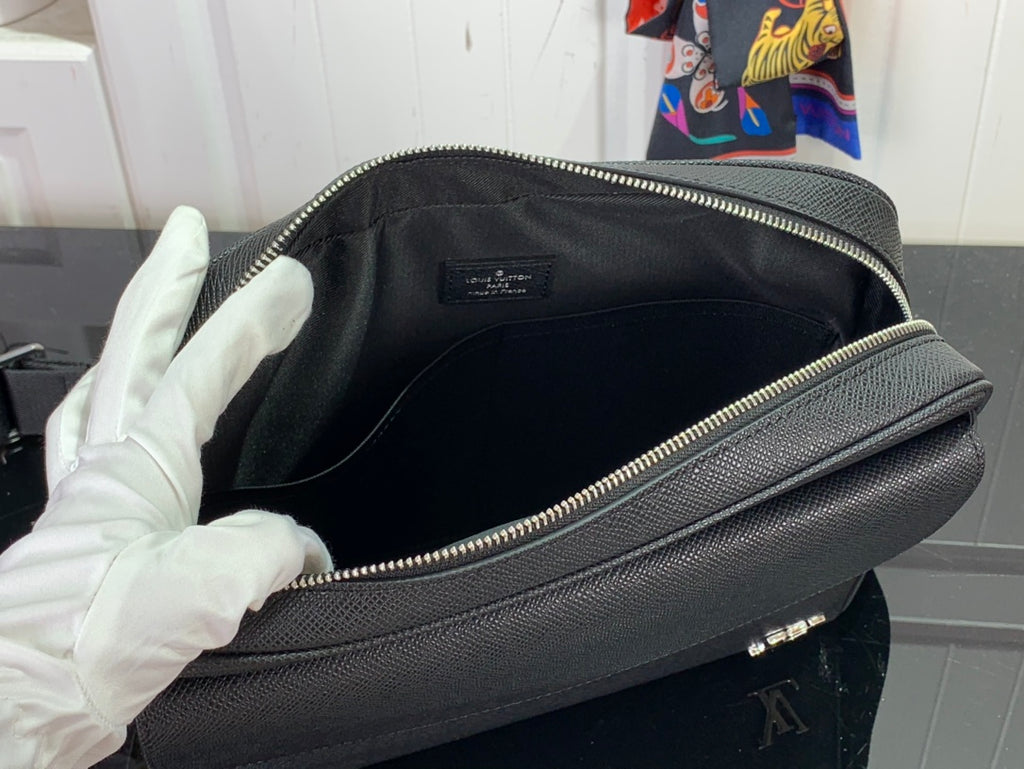 Louis Vuitton bag interior view with zippered opening and black lining, gold zipper trim