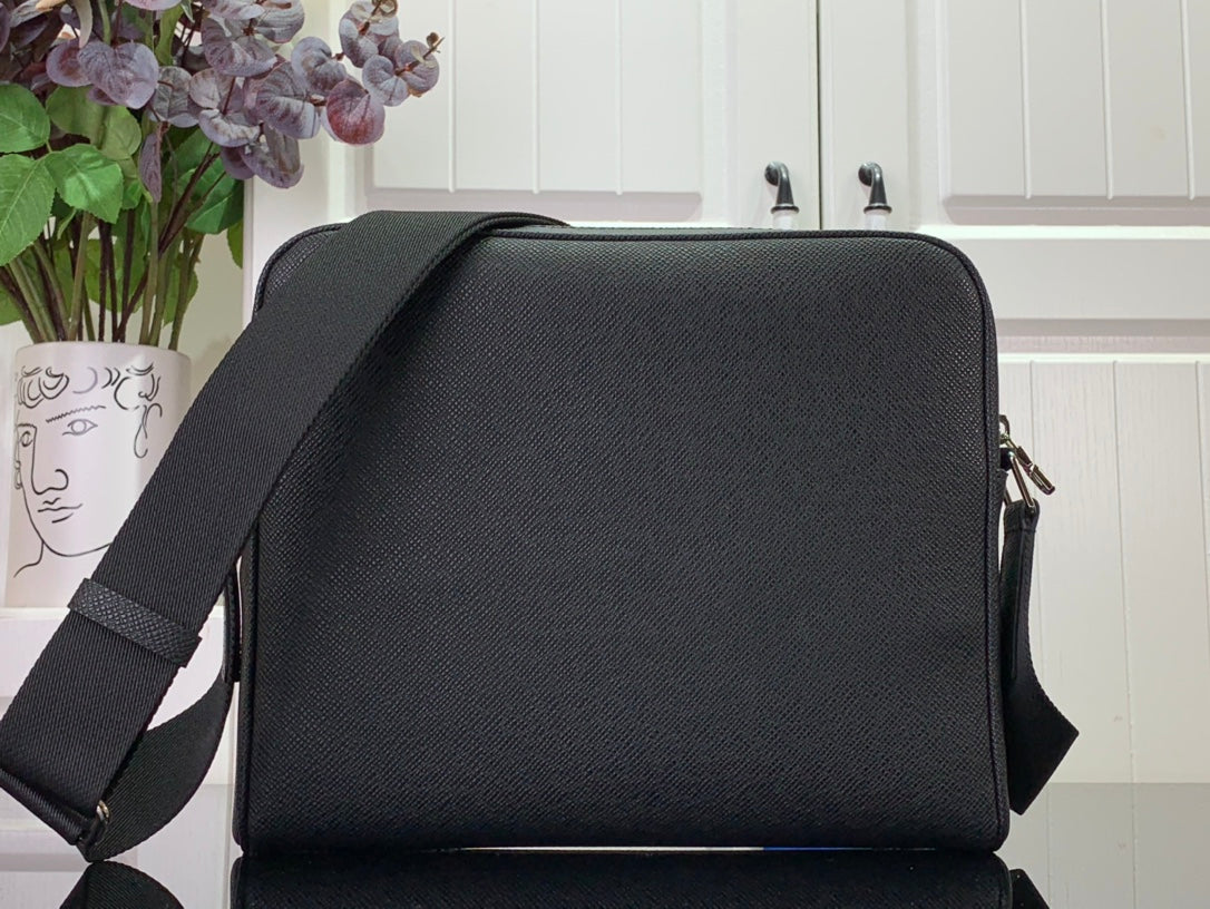 Louis Vuitton bag back view, black textured leather with top flap and side zipper closures
