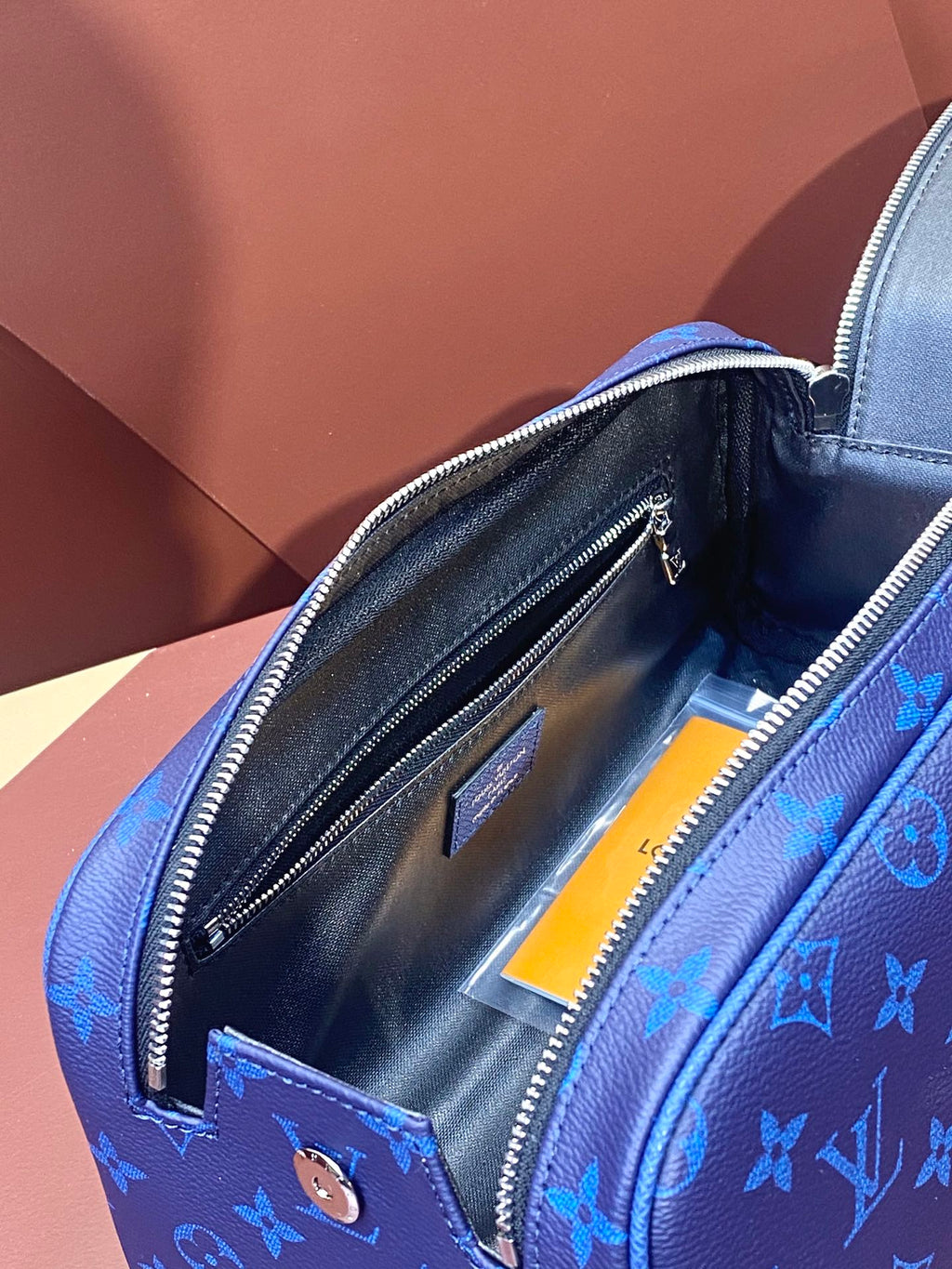Blue monogram zip bag interior with slip pockets
