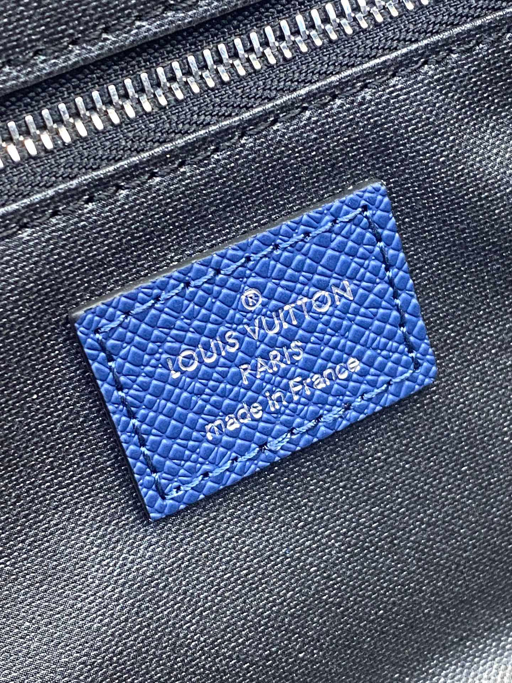 Blue monogram leather patch with embossed Louis Vuitton logo