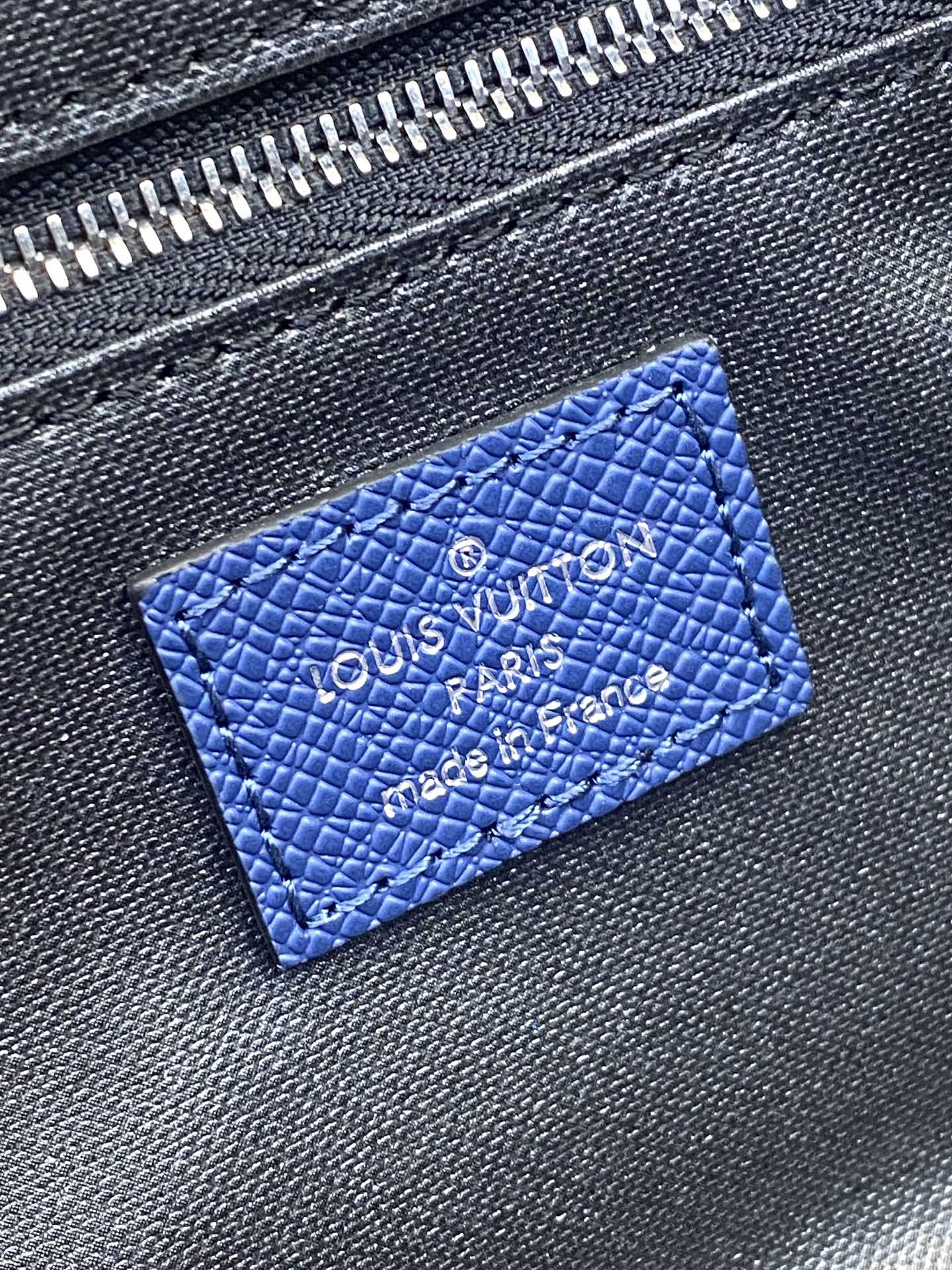Blue monogram leather patch with embossed Louis Vuitton logo