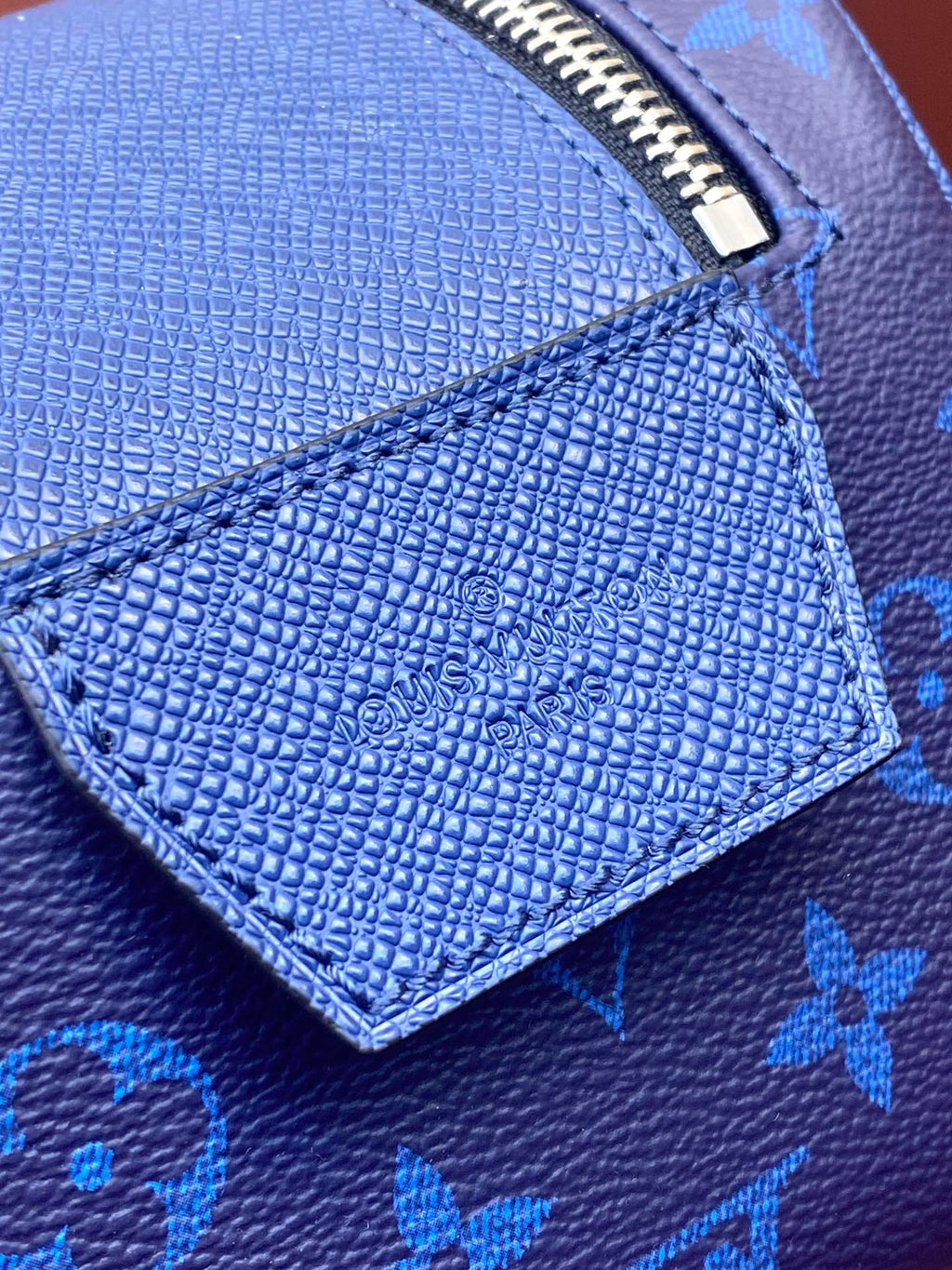 Blue monogram grained leather panel with embossed logo