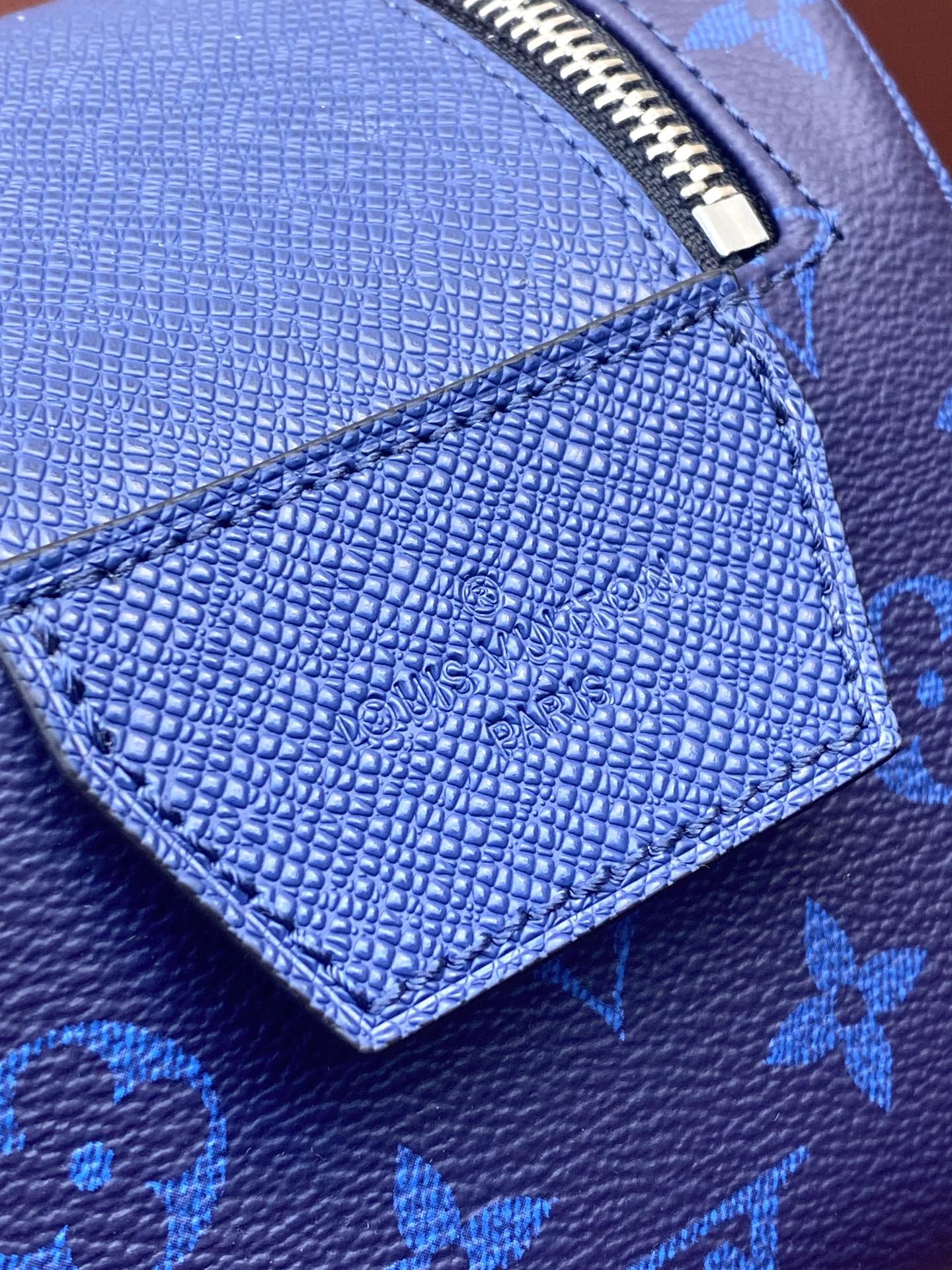 Blue monogram grained leather panel with embossed logo