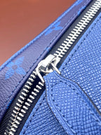 Silver zipper pull on blue monogram leather edge detail