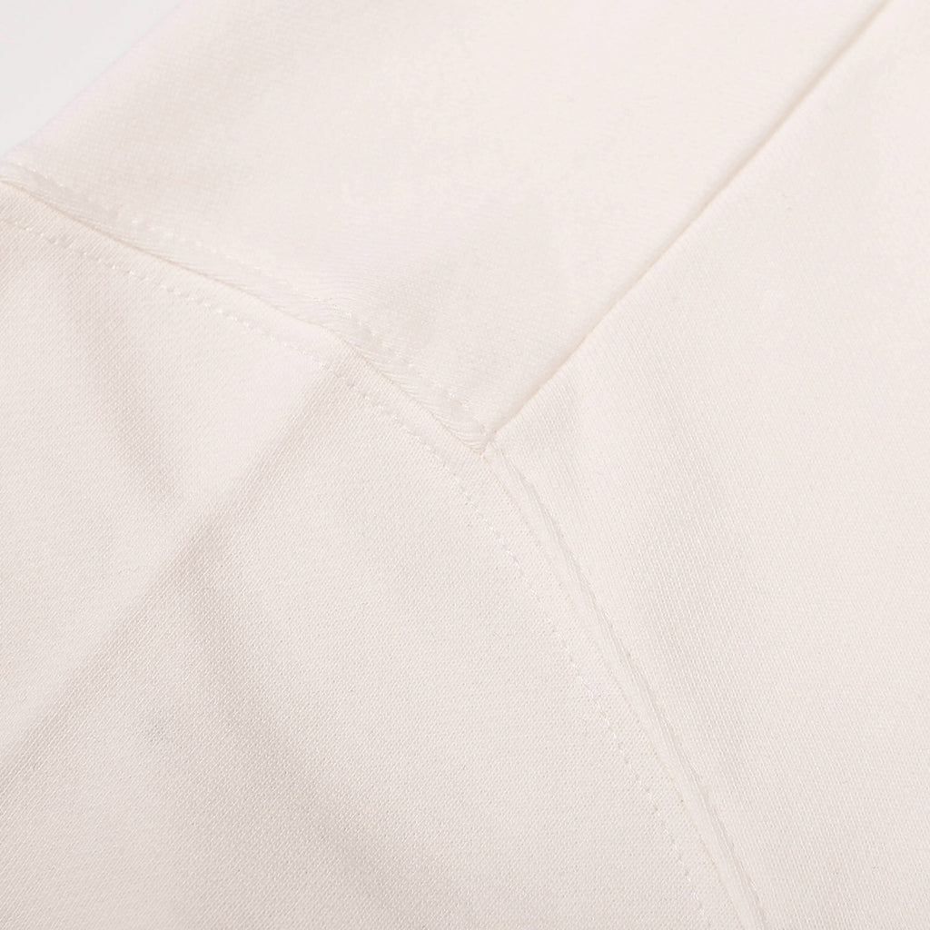 White sweatshirt side seam with stitched panel