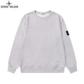 Grey crewneck sweatshirt with long sleeves and Stone Island sleeve patch