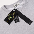 Grey crewneck sweatshirt neckline with Stone Island label and black hang tag