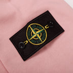 Pink sweatshirt with black logo patch featuring Stone Island crest