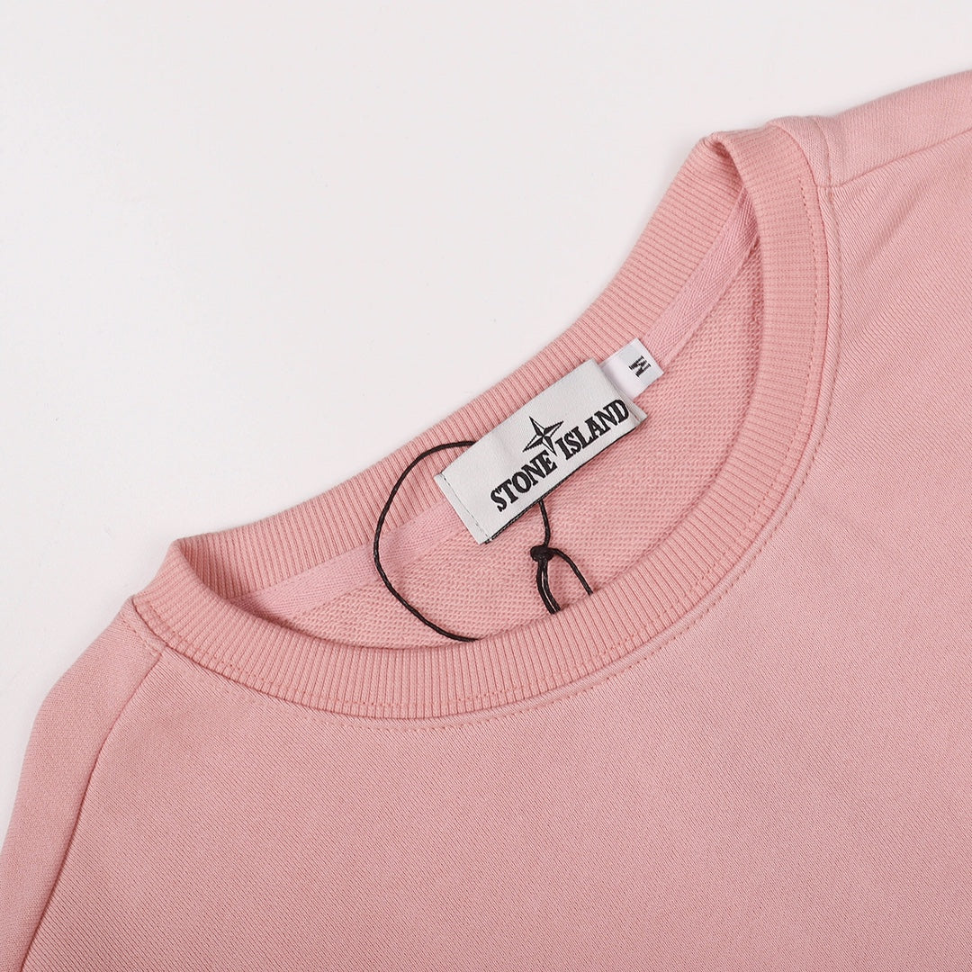Pink crewneck sweatshirt neckline with Stone Island logo label