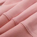 Pink sweatshirt fabric texture with ribbed hem and stitched seams