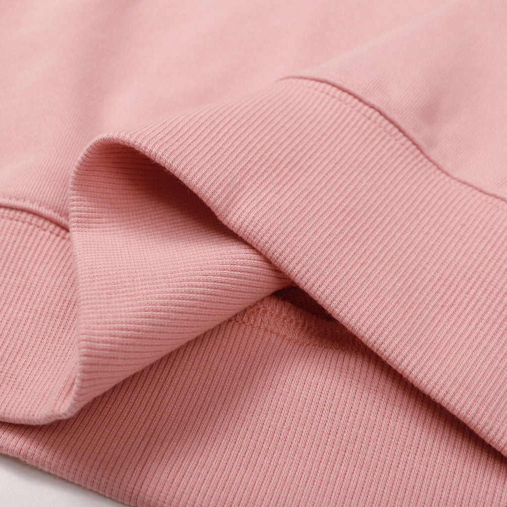 Pink ribbed cuff and sleeve fold detail on a sweatshirt