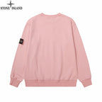 Pink crewneck sweatshirt with small logo patch on the sleeve