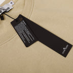 Beige crewneck sweatshirt showing neck tag and size/care labels