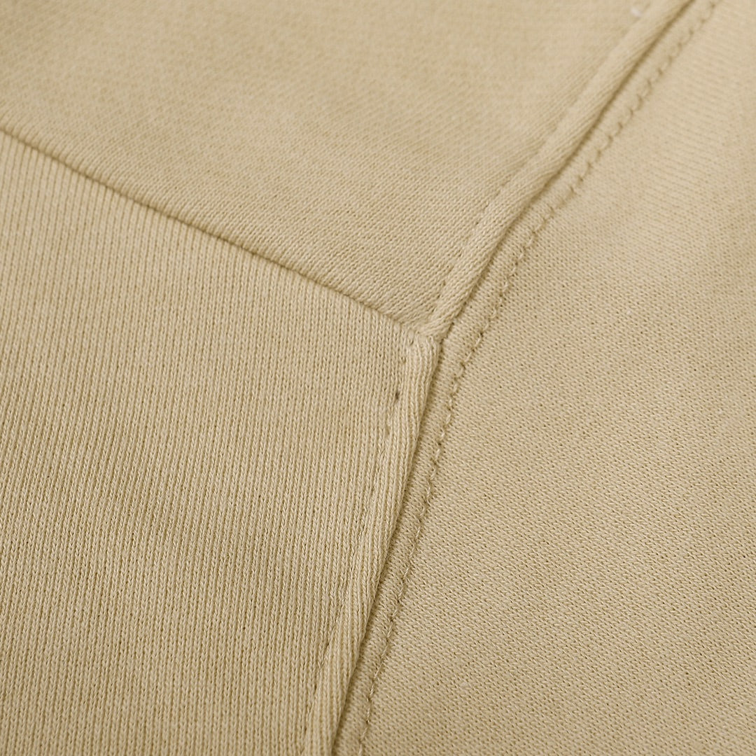 Beige crewneck sweatshirt side seam with ribbed knit cuff detail