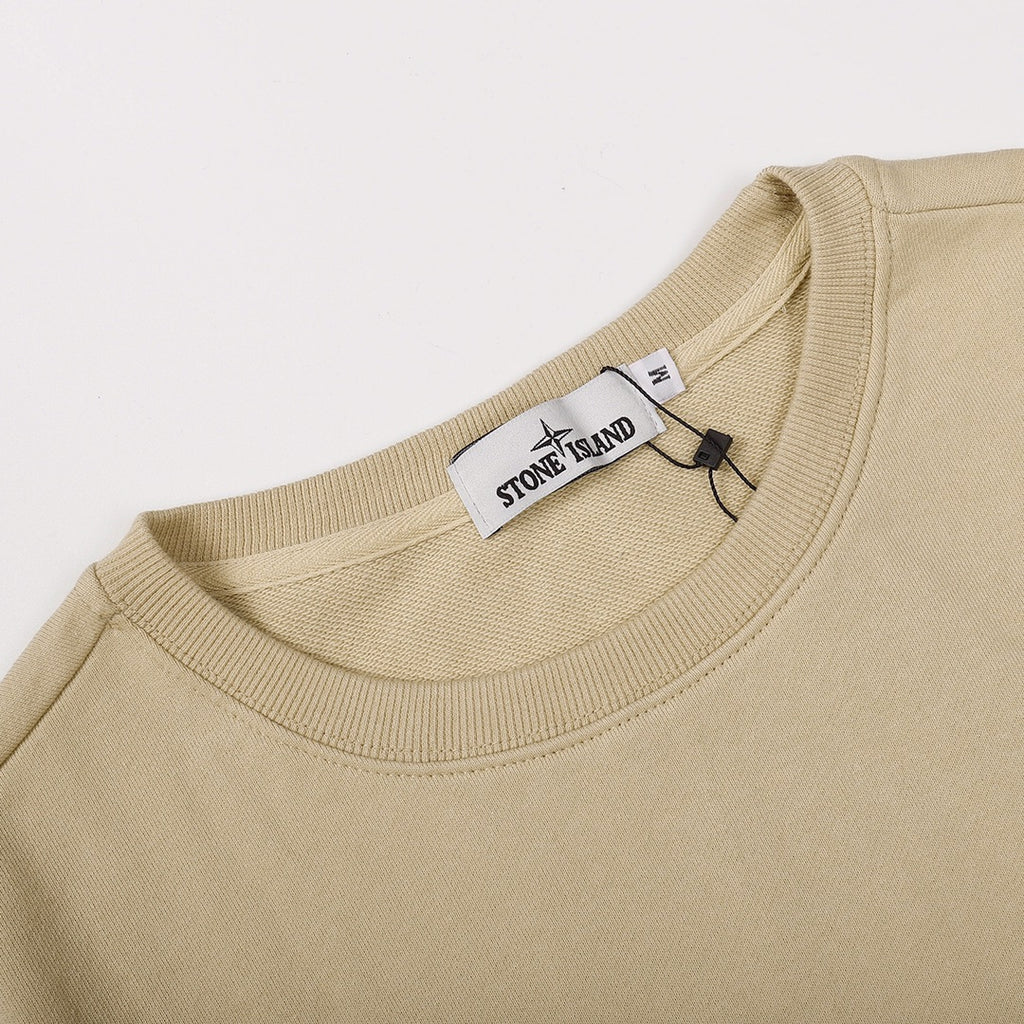 Beige crewneck sweatshirt neckline with ribbed collar and inner tag