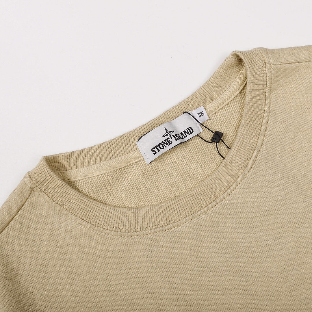 Beige crewneck sweatshirt neckline with ribbed collar and inner tag