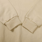 Beige crewneck sweatshirt sleeve cuffs and ribbed hem detail
