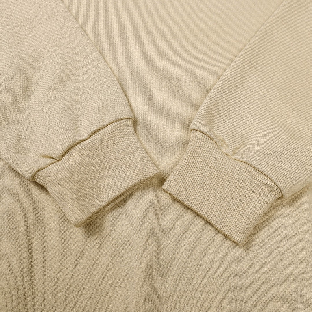 Beige crewneck sweatshirt sleeve cuffs and ribbed hem detail