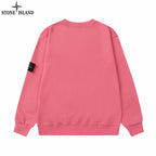 Stone Island crewneck sweatshirt in pink with ribbed cuffs and hem; black logo patch on sleeve
