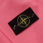 Stone Island pink sweatshirt with black fabric logo patch and yellow emblem detail