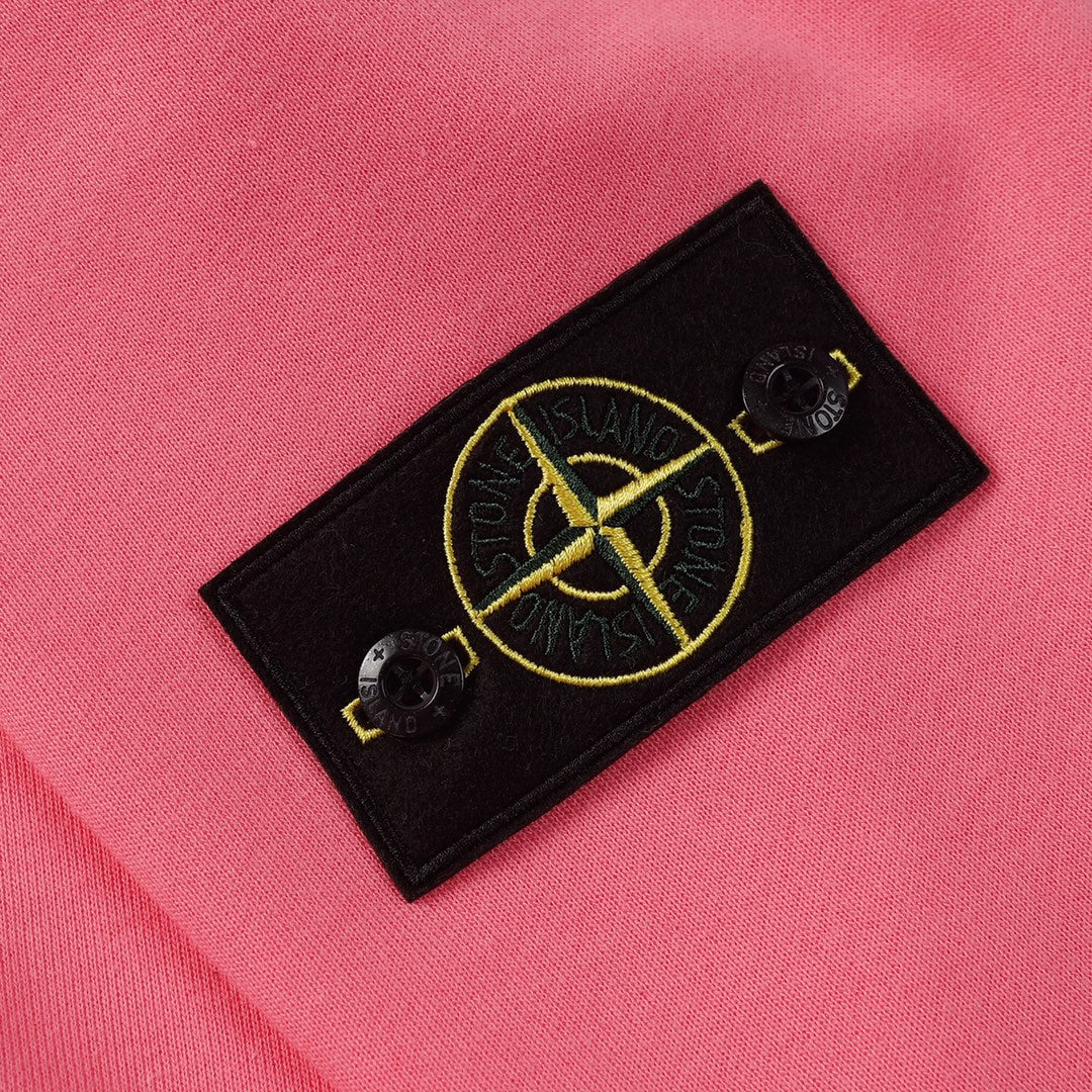 Stone Island pink sweatshirt with black fabric logo patch and yellow emblem detail