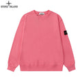 Stone Island crewneck sweatshirt in pink with ribbed cuffs and hem; black logo patch on sleeve