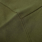 Olive green sweatshirt waistband close-up with stitched ribbed edge