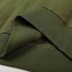Olive green sweatshirt close-up of ribbed cuff and stitched hem