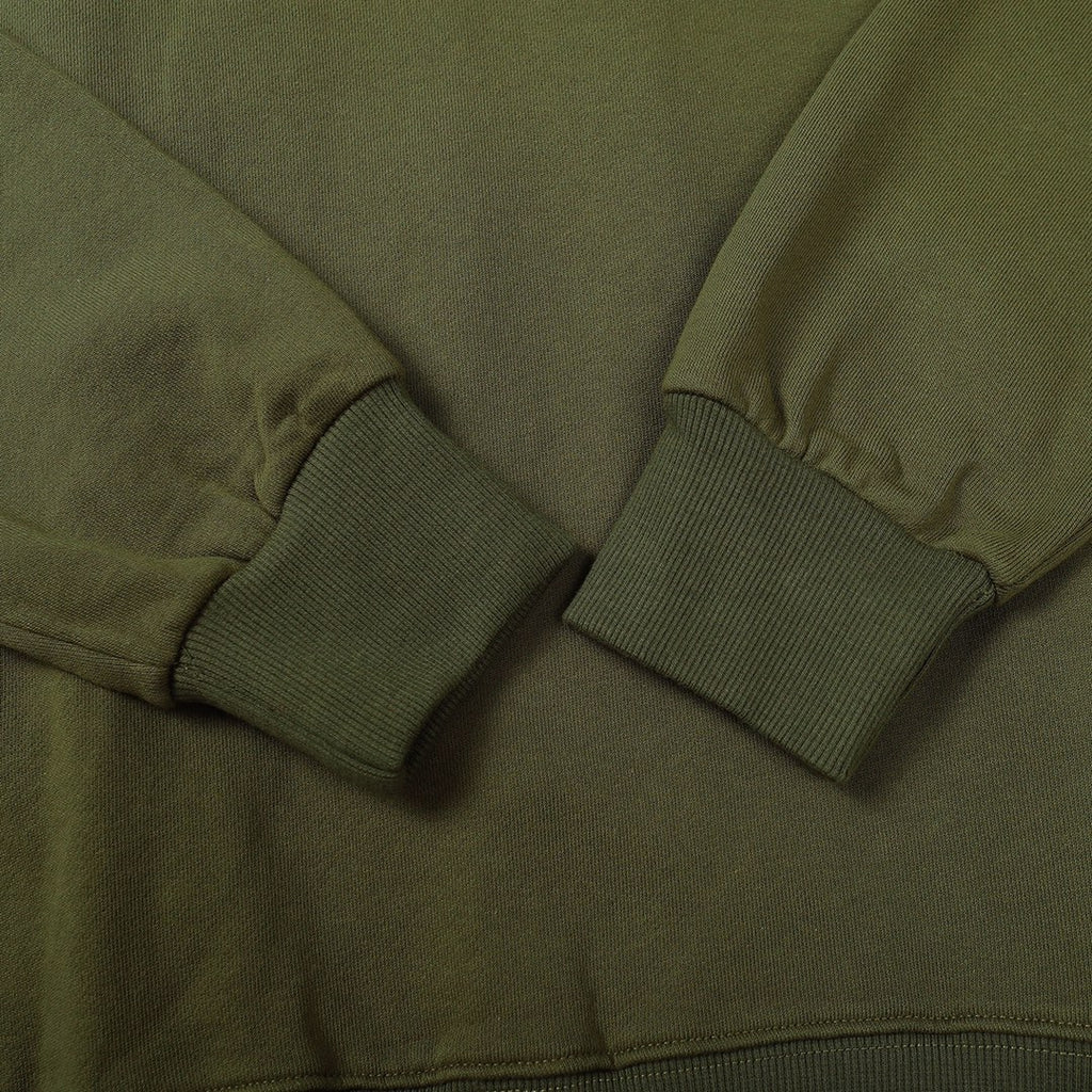 Olive green sweatshirt close-up of crew neck seam and ribbed sleeve cuff