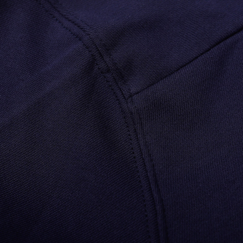 Navy sweatshirt close-up of front seam with subtle stitch detail