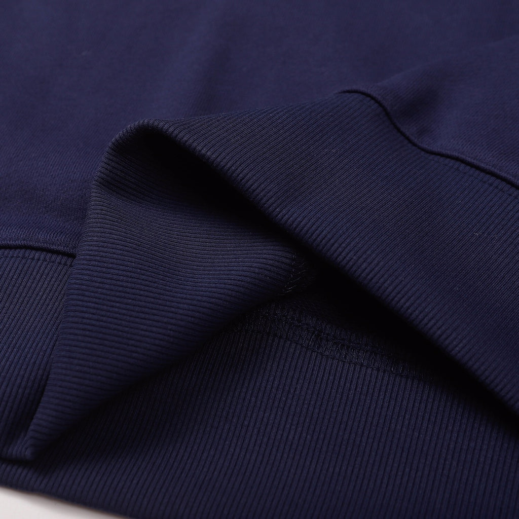 Navy sweatshirt fabric texture with rolled fold near the hem