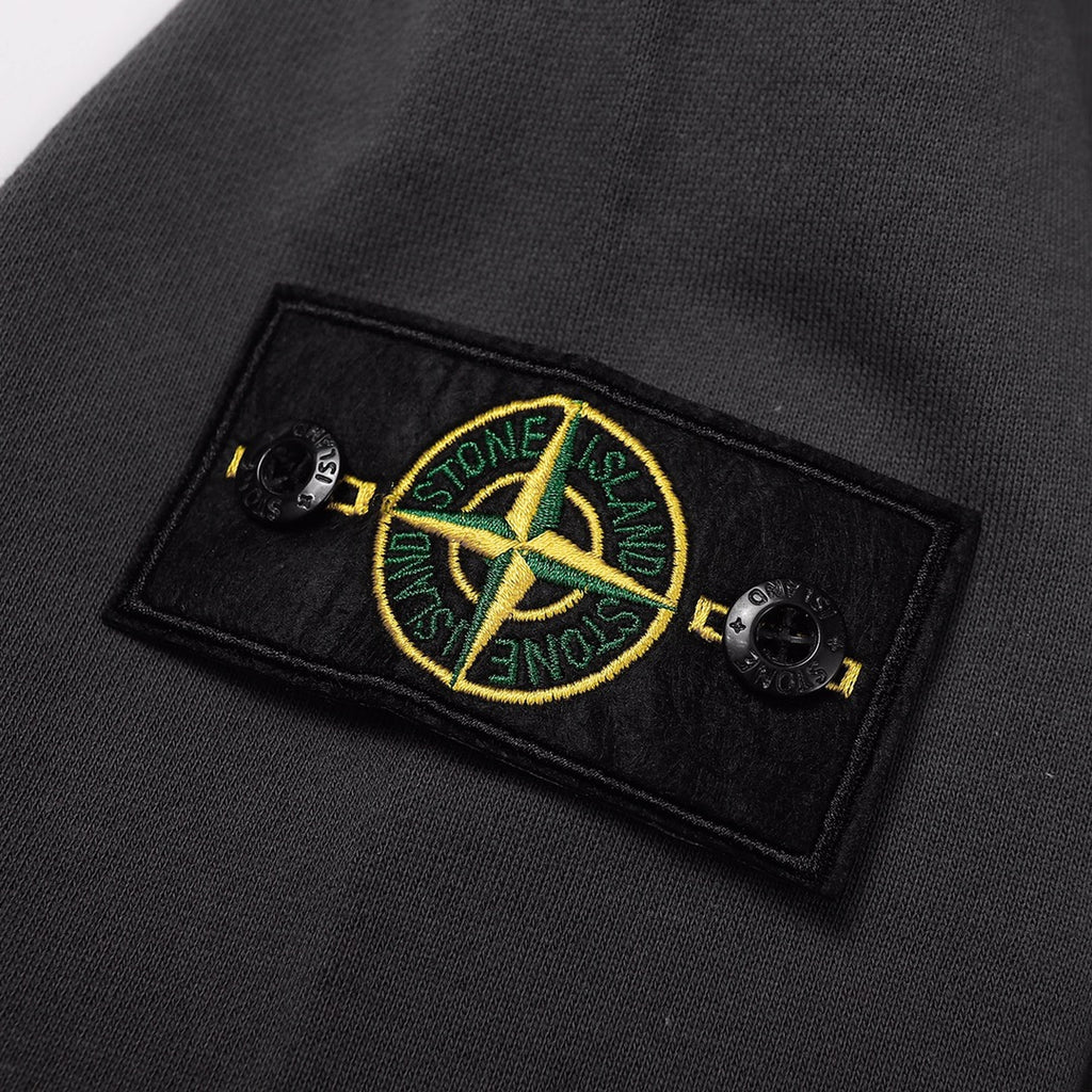 Crewneck sweatshirt chest logo patch with yellow and green emblem on dark black