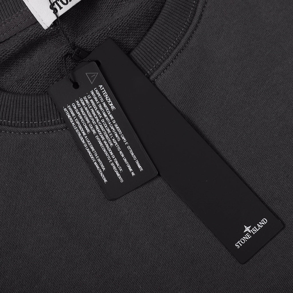 Crewneck sweatshirt neckline label area, dark black rib knit and inner tag