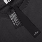 Crewneck sweatshirt neckline label area, dark black rib knit and inner tag