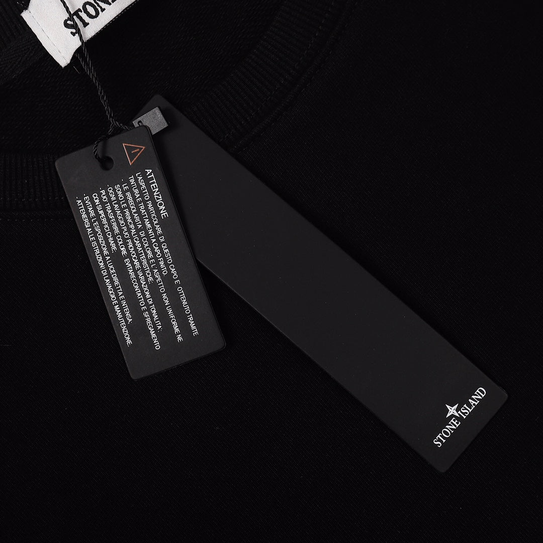 Stone Island black crewneck sweatshirt fabric tag and sleeve logo
