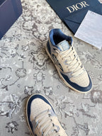 Dior unisex sneakers, cream and navy, lace-up with CD logo and perforated toe.