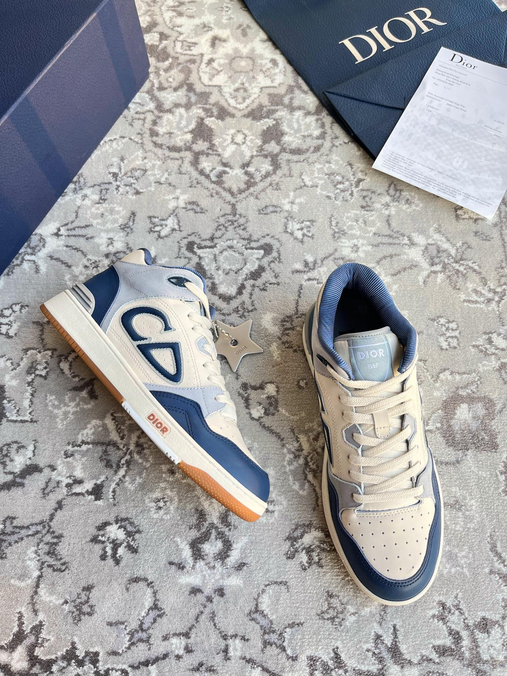 Dior unisex low-top lace-up sneakers, cream and navy, CD logo on sides.