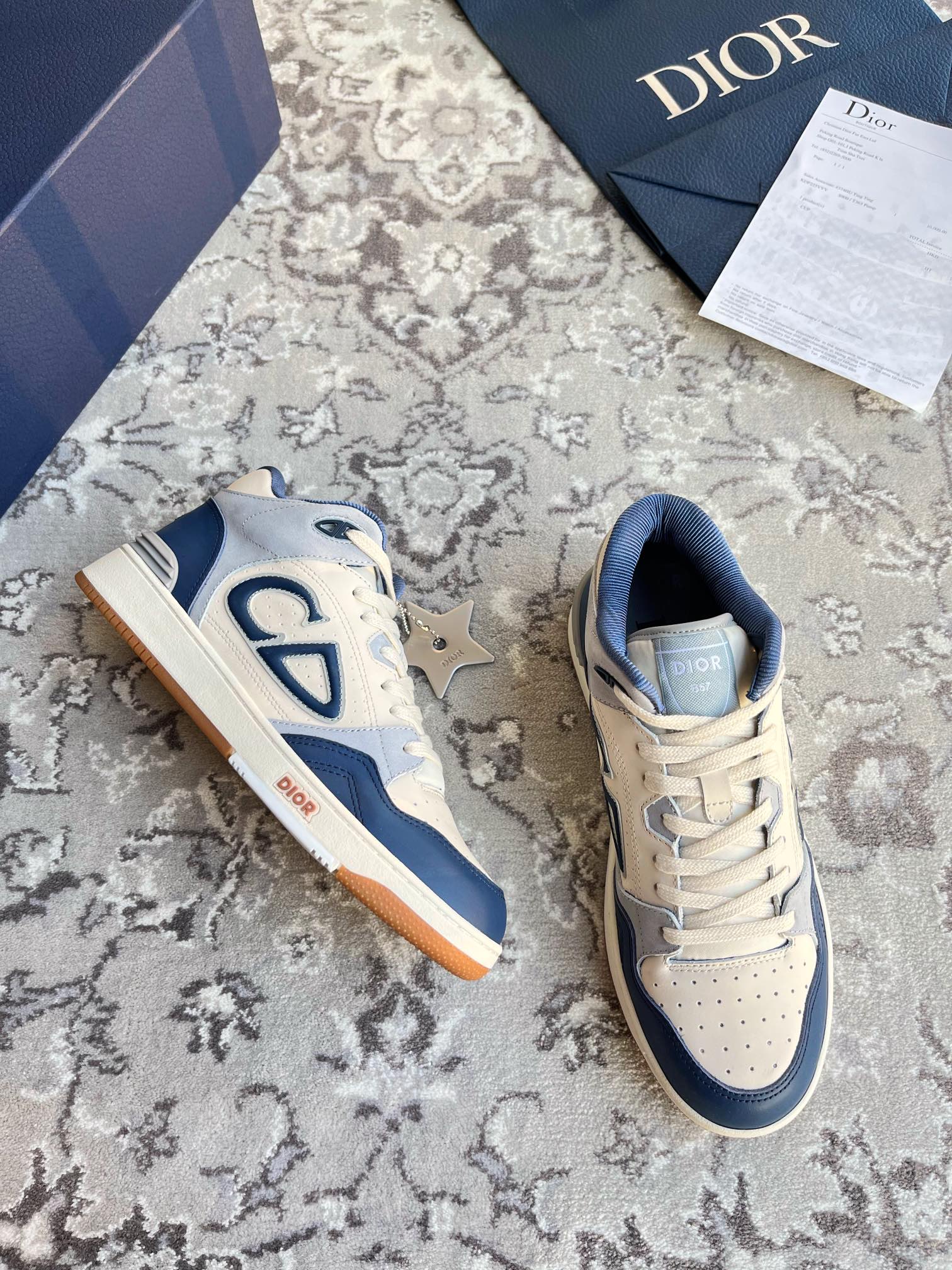 Dior unisex low-top lace-up sneakers, cream and navy, CD logo on sides.