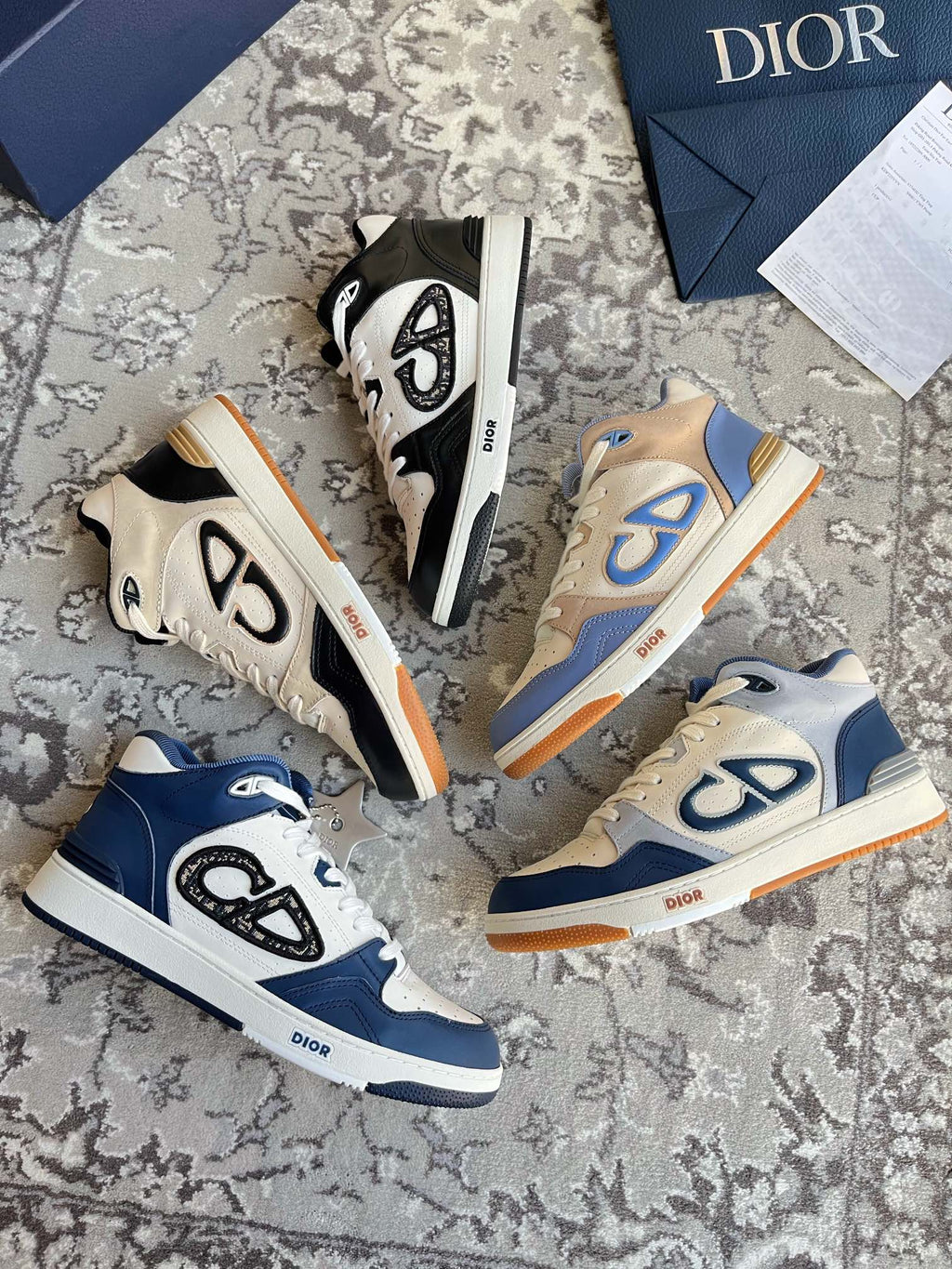 Dior unisex sneakers in blue and cream with CD logo accents and orange outsoles.