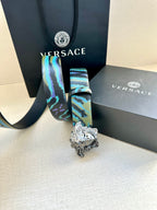 Versace belt with blue and teal patterned strap and silver Medusa buckle, hanging end