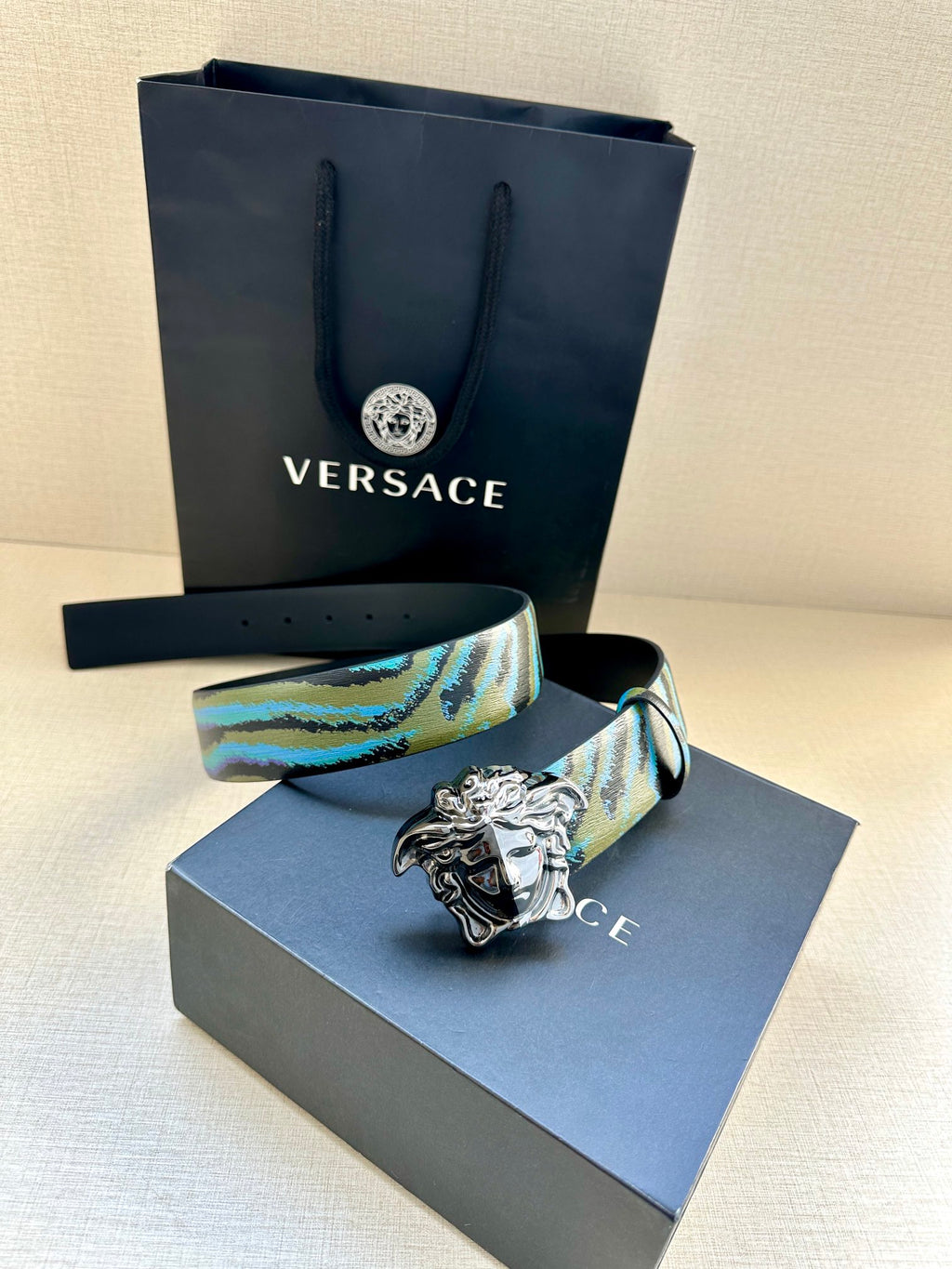 Versace belt with blue and teal patterned strap, silver Medusa buckle, sizing holes