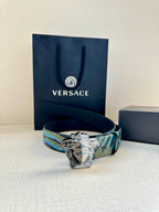 Versace belt with blue and teal patterned strap and silver Medusa-head buckle