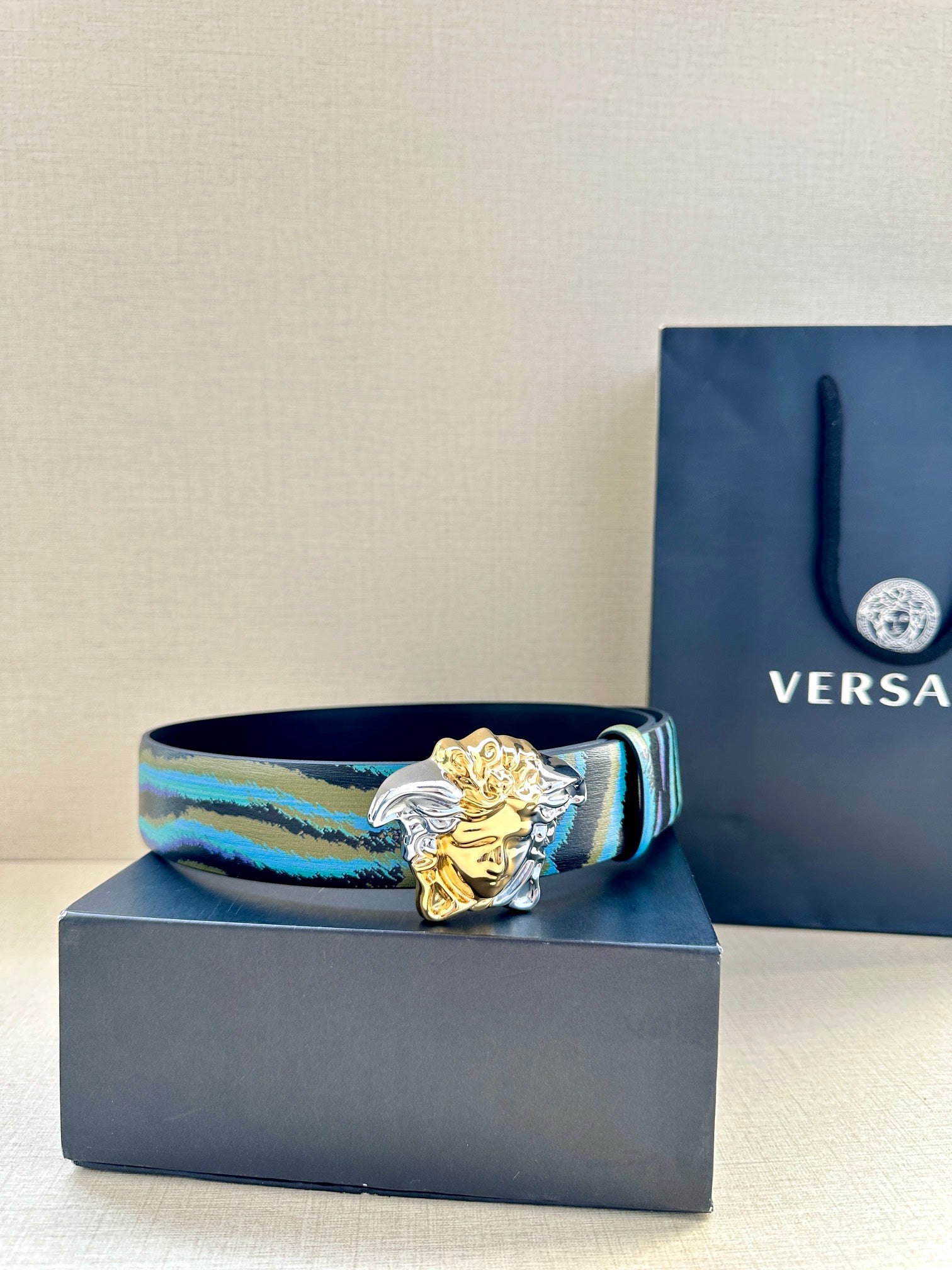 Versace belt with blue teal striped strap and gold Medusa buckle with silver side ornament