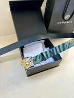Flat-lay belt in blue, teal and purple patterned strap with Medusa gold-silver buckle