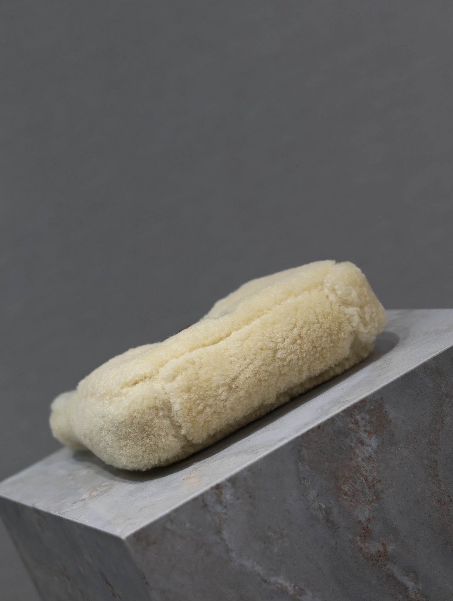 YSL shearling bag, cream teddy fabric with stitched seams in a long clutch-like shape