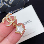 Gold-tone CC star charm earring with white enamel star and rhinestone details