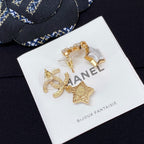 Gold-tone CC star charm earrings with white enamel stars and rhinestone details on card