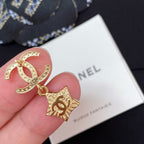 Gold-tone CC star charm earring with white enamel star and rhinestone trim